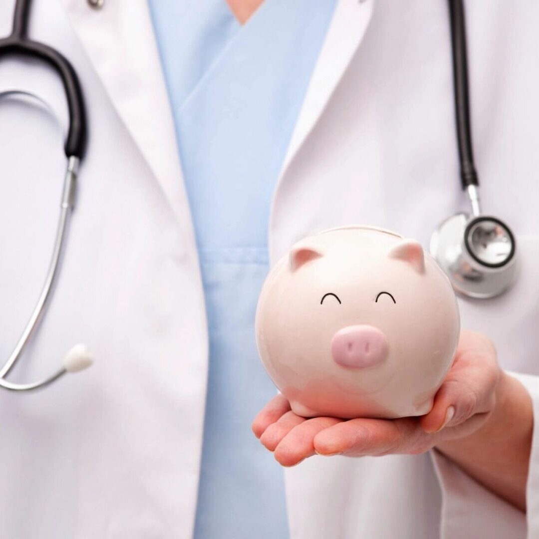 Doctor Holding Piggy Bank